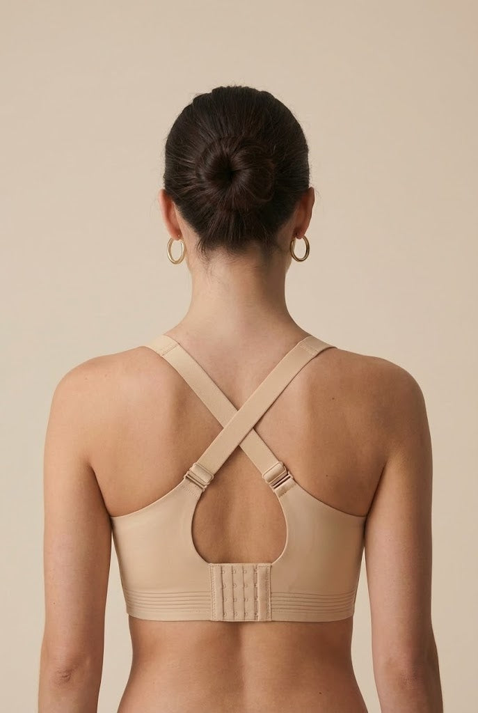 Beige sports bra worn by a person on a beige background